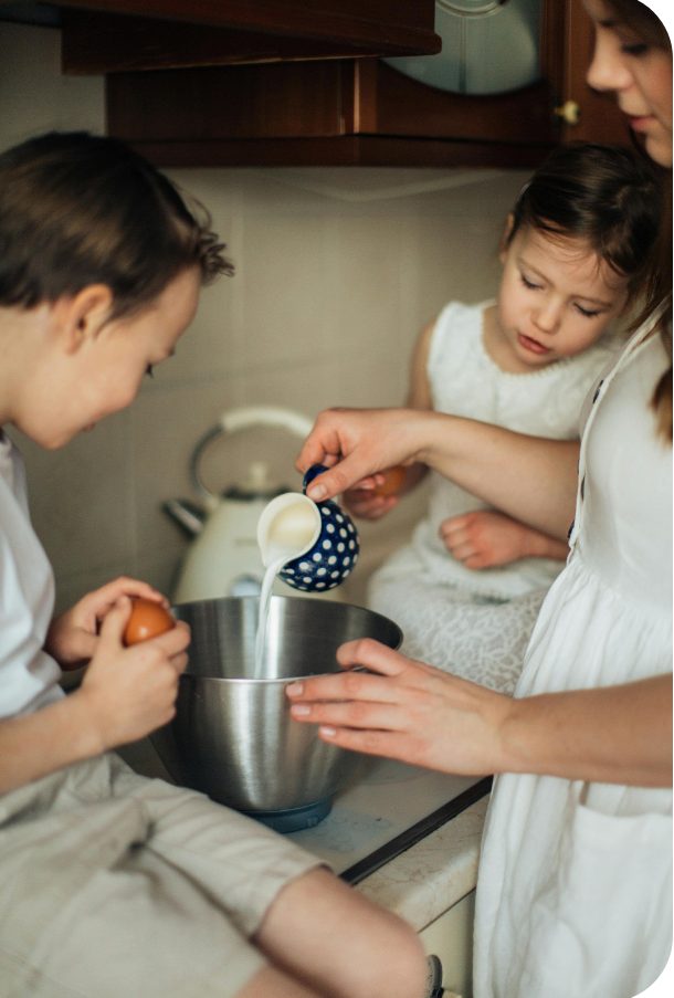 Mutter backt gemeinsam mit ihren Kindern in der Küche
